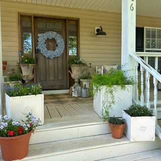 White square planters styled on farmhouse porch steps