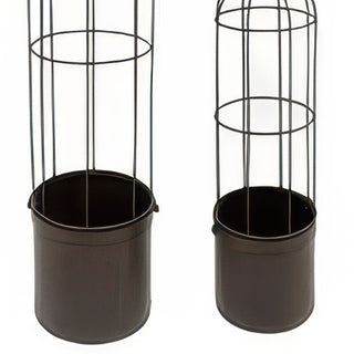 Farmhouse style metal trellis planters with trailing greenery on covered porch
Distressed finish metal garden obelisk planters with bird accents