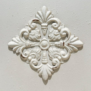 Decorative raised medallion detail on white planter