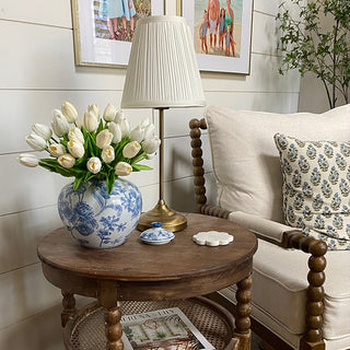 Living room with a wooden side table, lamp, and floral arrangement in a Chinoiserie Ginger Jar