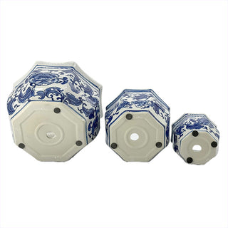 Three round ceramic planters with scalloped blue rims and floral motifs
