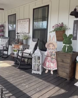 bunny sign with bunny topiaries in wood planters easter decor and spring decor on front porch