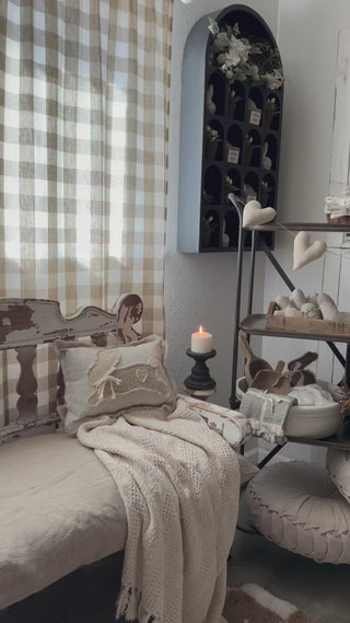 arch wall shelf filled with faux potted plants and bunny figurines inside a cottage home