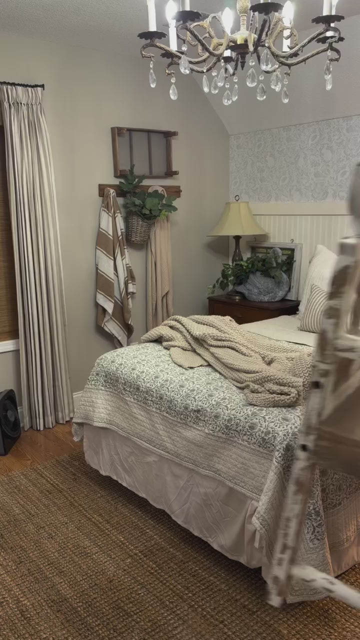 Cozy bedroom with wooden bench, bed, and decorative elements.