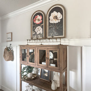 Rustic arched floral wall art above farmhouse cabinet