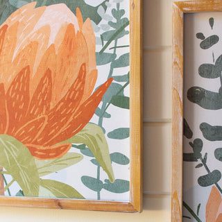 Close-up corner detail of natural wood frame on botanical protea wall art print with orange and green florals