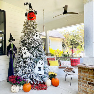Halloween porch with flocked Christmas tree decorated with ghosts