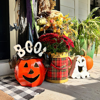 Outdoor fall porch display with metal jack-o'-lantern pumpkin decoration