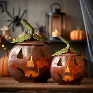 Pair of rustic metal jack-o’-lantern candle holders