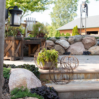 Outdoor garden display with metal wire pumpkin planters