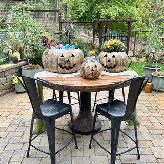 Outdoor patio table with three metal pumpkin containers