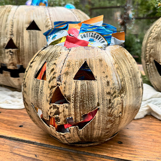 Small rustic metal jack-o'-lantern container