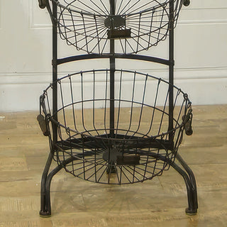 Bottom basket detail of 4-tier metal storage stand showing sturdy black metal frame and curved legs