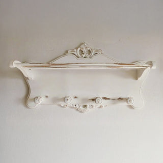 Vintage style white wall shelf with hooks and wooden dowel rods side view