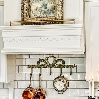 Farmhouse brass wall hook rack above stove backsplash