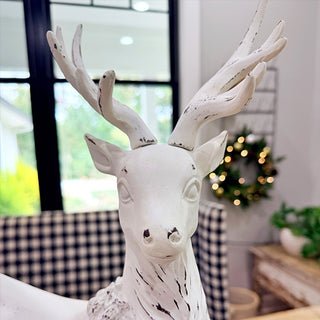Close-up front view of white distressed resin reindeer figurine showing detailed antlers and smooth matte finish for Christmas decor