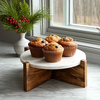  Marble and wood elevated display riser with chocolate chip muffins and holiday greenery on white kitchen windowsill