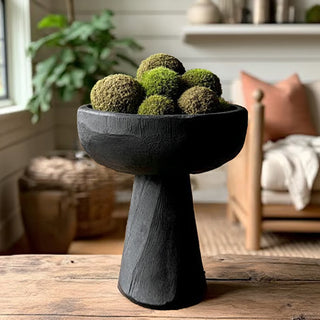 Black pedestal bowl with moss decorative centerpiece