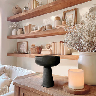 Minimal black wooden pedestal bowl on rustic console