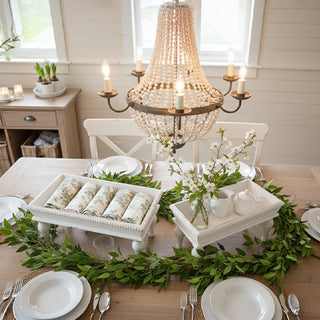 Farmhouse dining table styled with white wooden riser trays