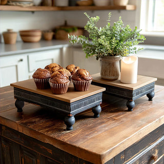 Farmhouse wood and metal display risers on kitchen table with muffins, greenery, and candle creating layered display
