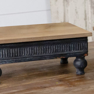 Side view of wood and metal riser showing 5.5-inch height and turned ball feet detail