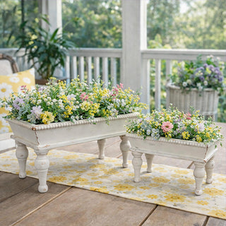 Person holding white wooden riser trays for scale
