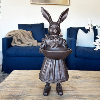 Full view Female Royal Hare statue bronze finish pleated dress mary jane shoes holding decorative bowl on wood table