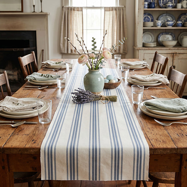 Close-up detail of red stripe paper table runner showing textured linen-look finish