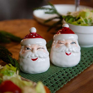 two santa's winking on a table