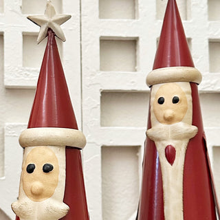 Close-up of handcrafted metal Santa figurines