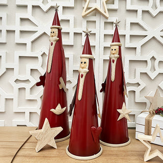 Rustic holiday decor featuring metal Santa Claus figurines