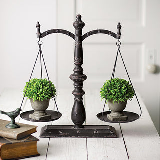 Farmhouse metal balance scale table decor with greenery