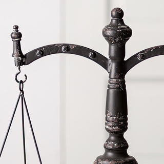 Close-up distressed metal balance scale arm detail