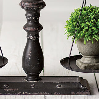 Rustic metal balance scale base with hanging planter

