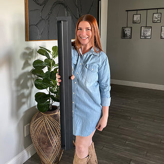 Woman holding modern black wall sconce light