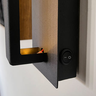 Close-up of black sconce on/off switch
