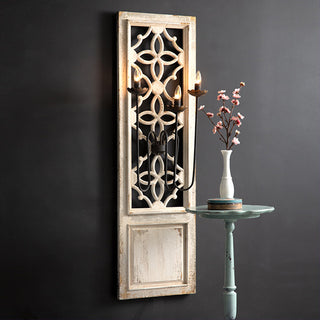 Close up carved wood detail ornate geometric pattern French country sconce antique white distressed finish