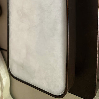 Close-up of frosted resin panel showing warm LED glow and distressed frame