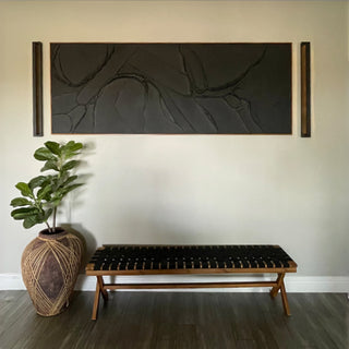 Entryway with black sconces and modern bench.