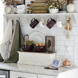 Farmhouse kitchen countertop decorated with a distressed wooden shelf