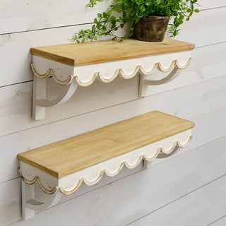Scalloped wall shelves with greenery decor.