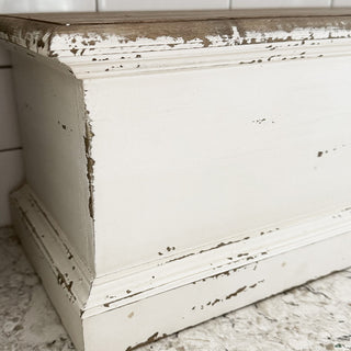 Close-up of distressed white painted shelf