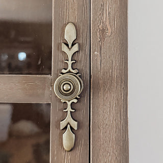 Vintage brass cabinet knob on distressed wood door