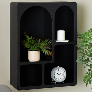 Black wooden wall shelf with plant and clock
