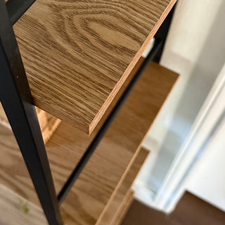Overhead view of solid wood shelf with visible grain and black metal frame, highlighting quality materials