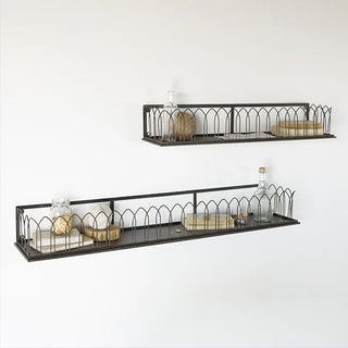 Metal wall shelf with cathedral arch design displaying jars books and decorative items