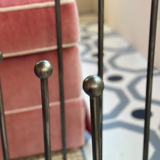  Detail shot of ball-topped poles on distressed iron boot storage rack