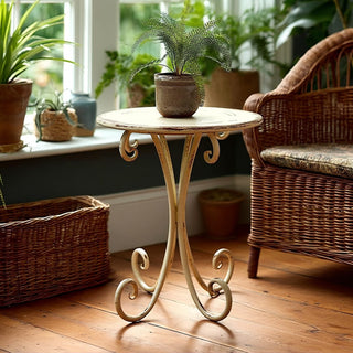 Round vintage metal accent table with scroll legs