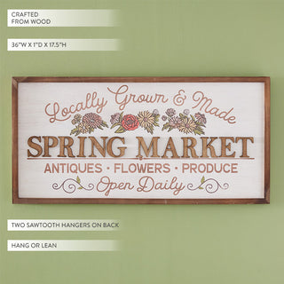 Spring Market vintage wood sign with hand-painted floral detail showing dimensions and sawtooth hangers on sage green wall